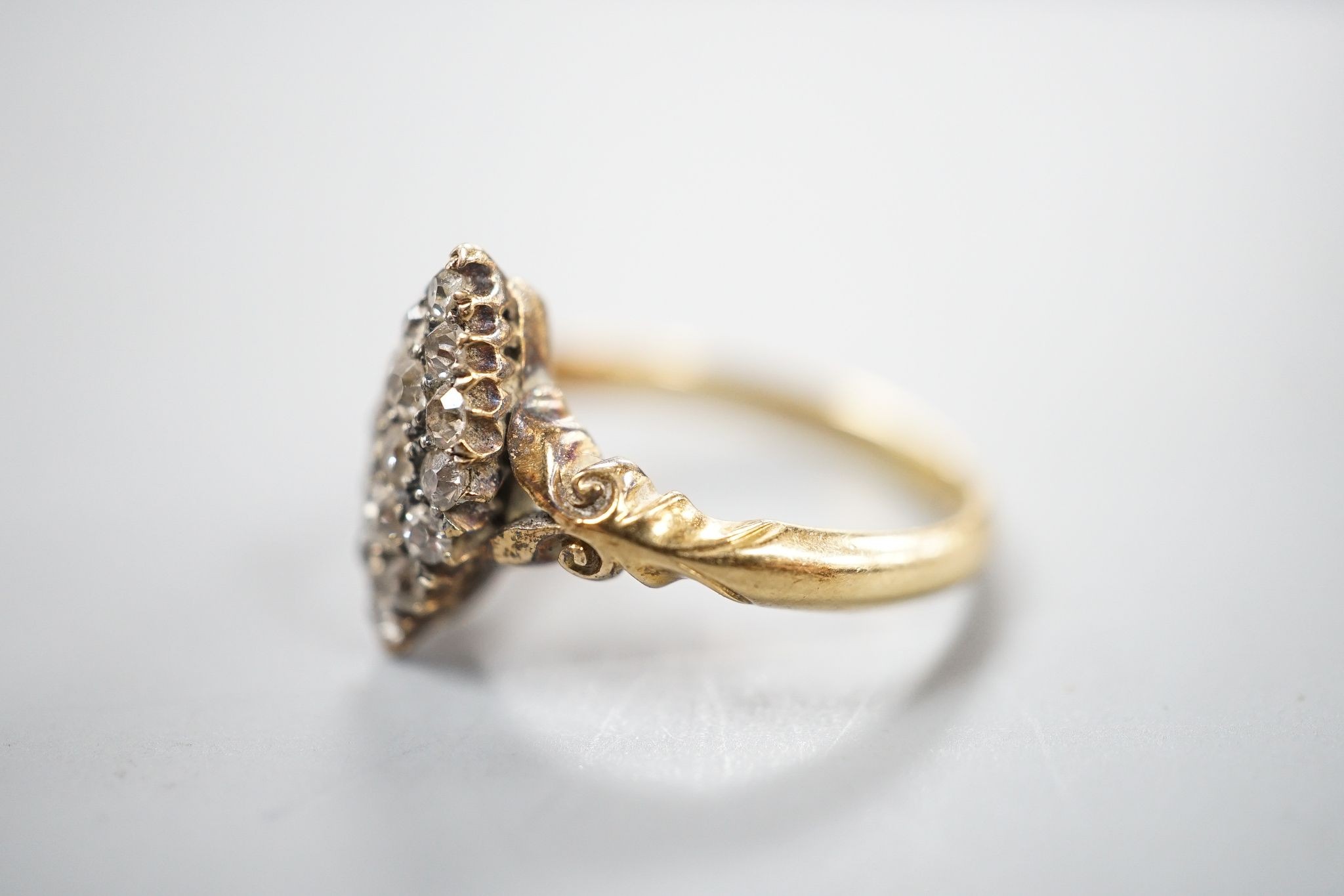 An 18ct and diamond cluster set marquise shaped ring, size K/L, gross 3.2 grams.